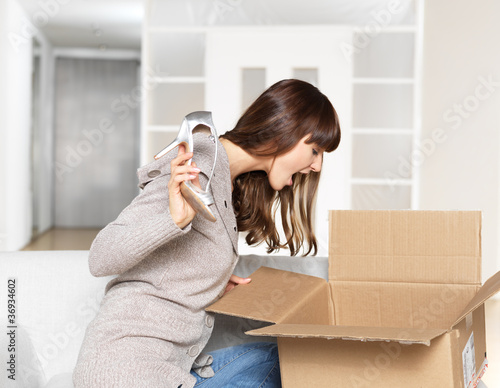 Young Woman opening parcel