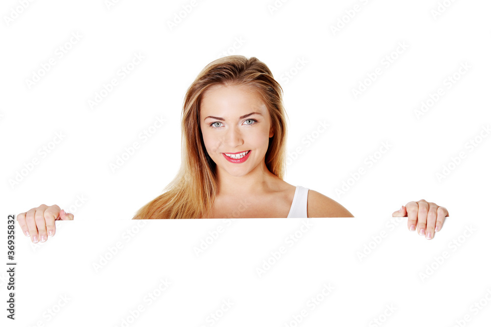 Beautiful blond teen girl behind big blank billboard Beautiful blond teen girl behind big blank billboard