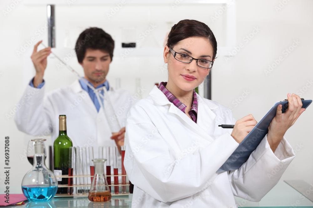 Laboratory workers testing wine Laboratory workers testing wine
