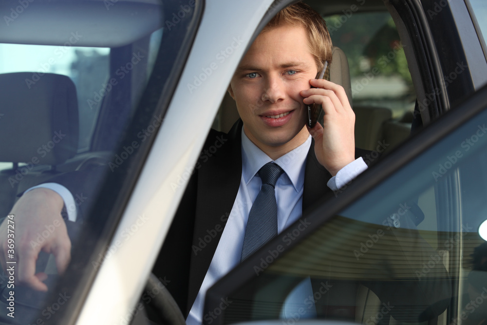 junior executive on the phone driving luxury car junior executive on the phone driving luxury car