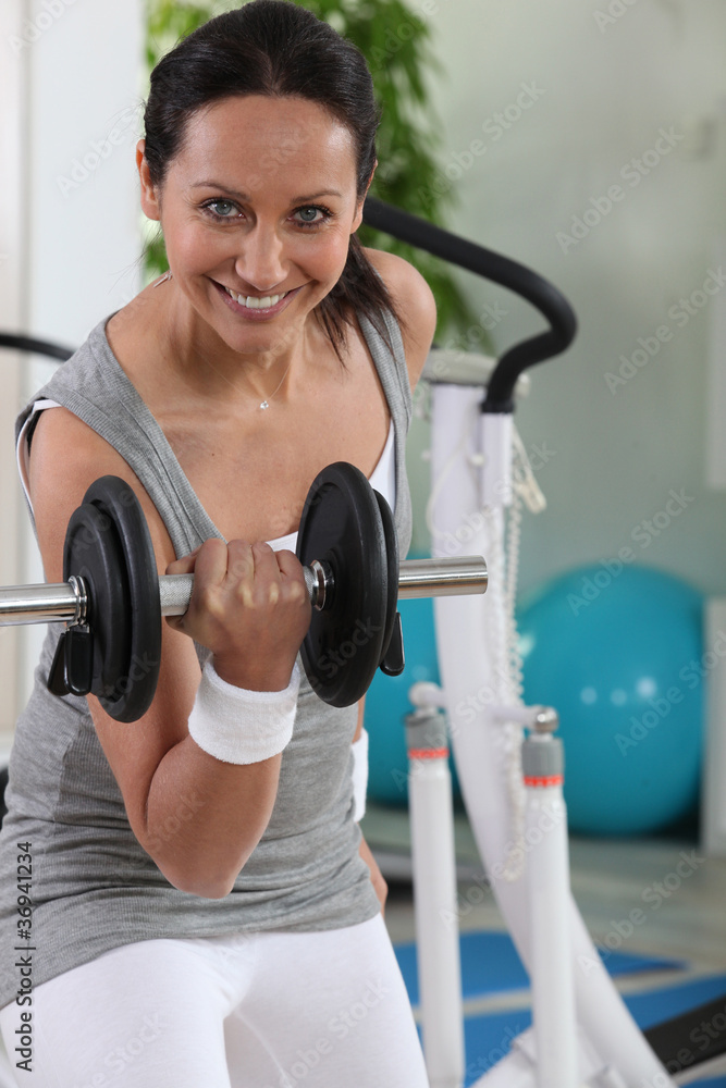 Woman using a dumbbell Woman using a dumbbell