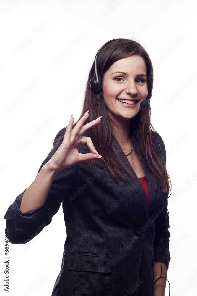 Smiling woman operator with headset showing hand ok sign Smiling woman operator with headset showing hand ok sign