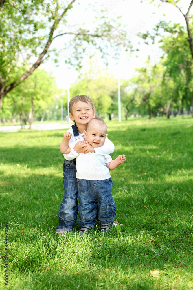 Two little brothers together in the park Two little brothers together in the park