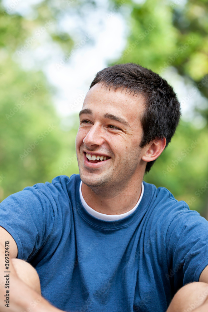 Portrait of a happy young man at the park
