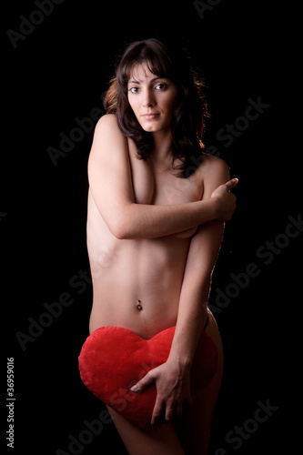 woman holding a heart shaped pillow