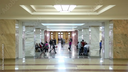 Students in symmetric hall in building