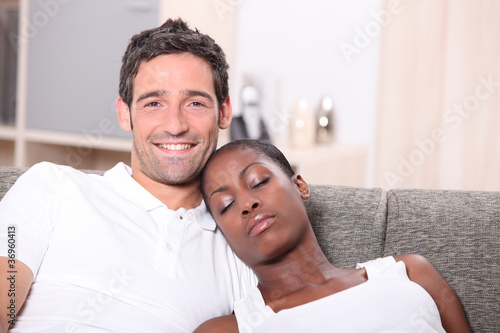 Woman sleeping on husband's shoulder photo