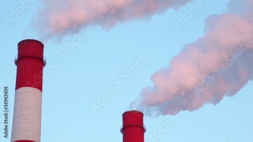 White smoke comes from two tubes against blue sky photo