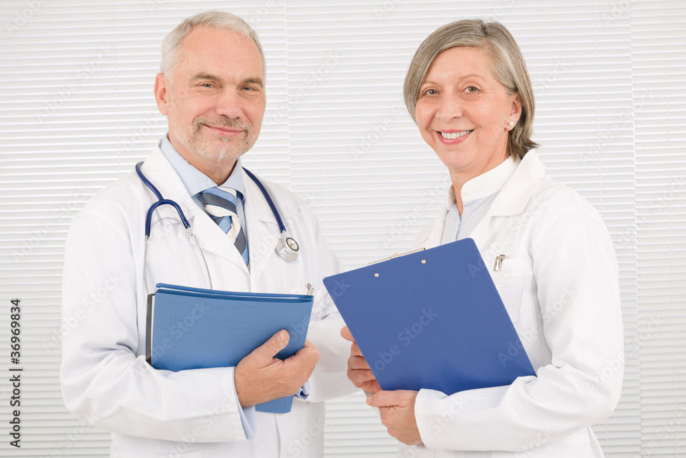 Medical doctor team seniors smiling hold folders Medical doctor team seniors smiling hold folders