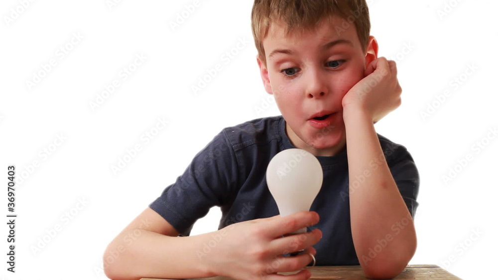 boy holds in hand light bulb that miraculously lights