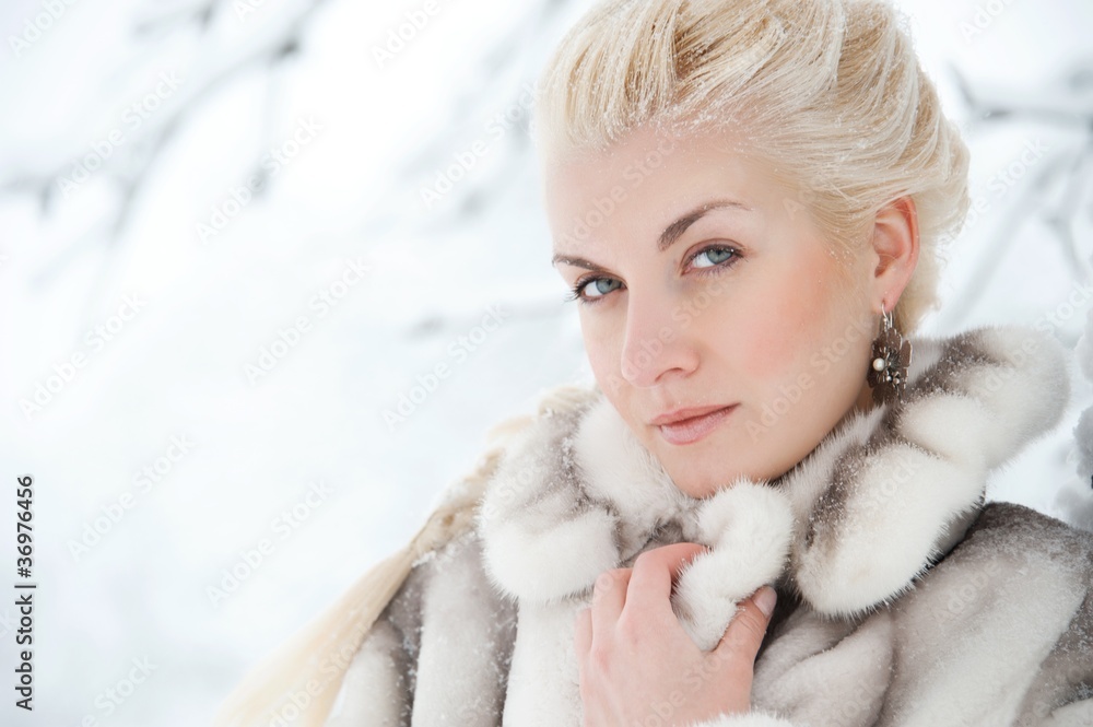 Attractive blond woman in fur coat.