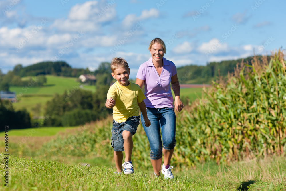 Family outdoors is running on a meadow Family outdoors is running on a meadow