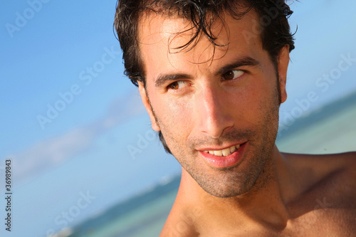 Handsome man standing on the beach