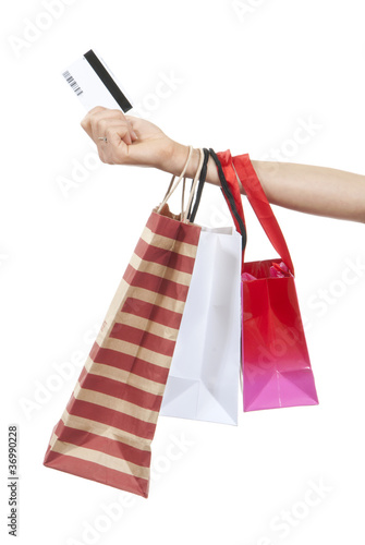 Hand with credit gift card and shopping bags