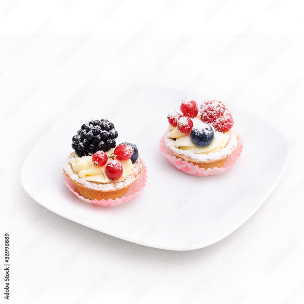 Two cakes on the plate. Isolated. Two cakes on the plate. Isolated.