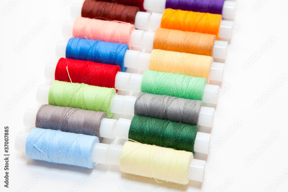 Colourful arranged reel of thread isolated on white Colourful arranged reel of thread isolated on white