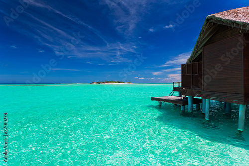 Over water bungalow with steps into blue lagoon © Martin Valigursky