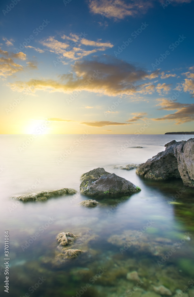Rock in sea on sunset. Rock in sea on sunset.