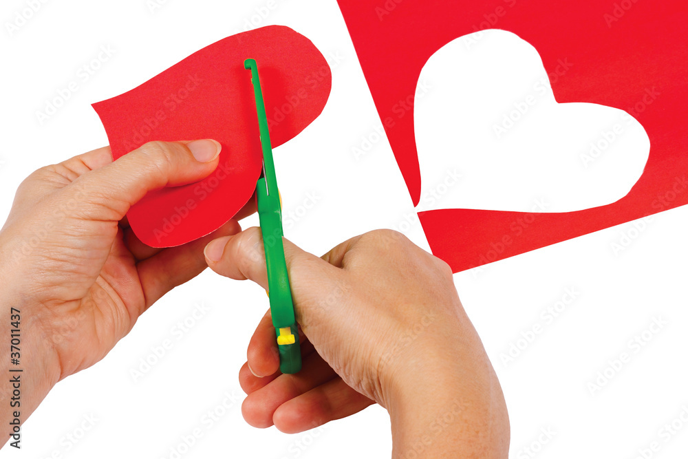 Creating red heart of colored paper on a white background Creating red heart of colored paper on a white background