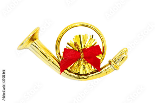 Golden christmas trumpet  and red ribbon on a white background