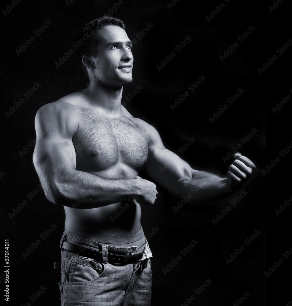 Fototapeta premium young muscular man on black background