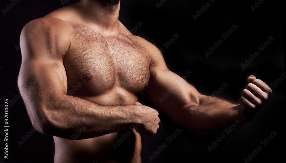 Fototapeta premium body of muscular man on black background