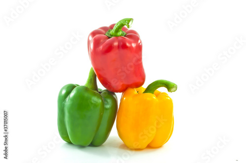 Red, yellow and green bell peppers isolated on the white backgro
