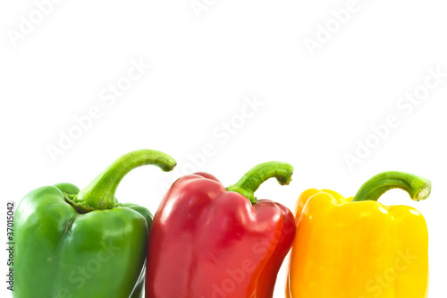 Red, yellow and green bell peppers isolated on the white backgro