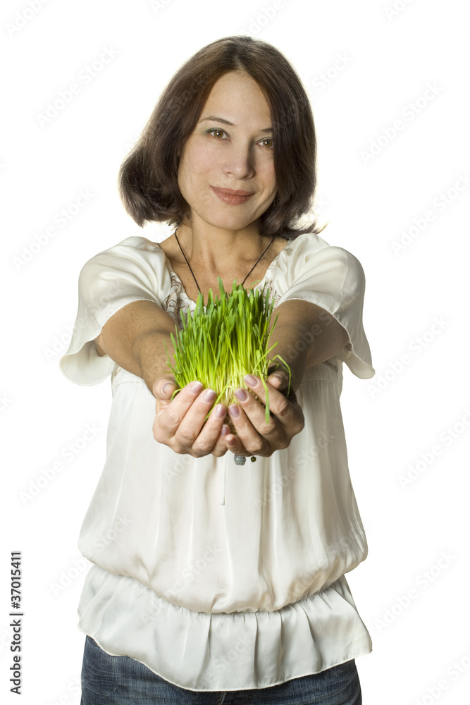 Beautiful smiling woman on grass in hands - nature protection