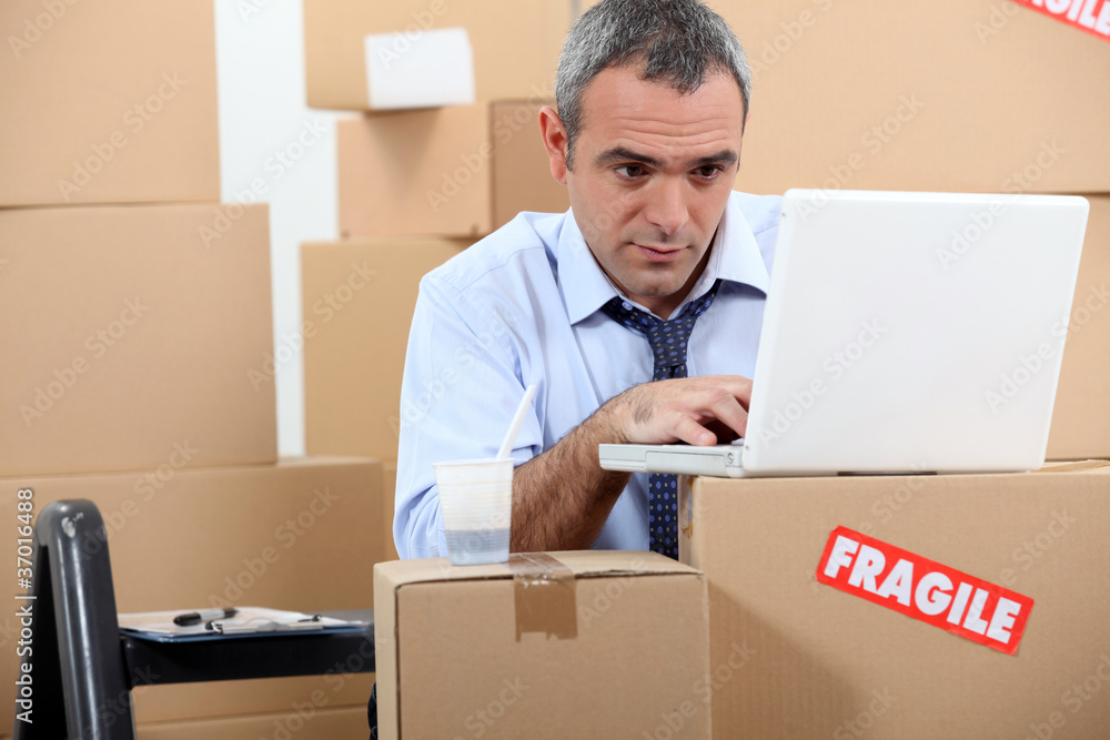 Man surrounded by boxes Man surrounded by boxes