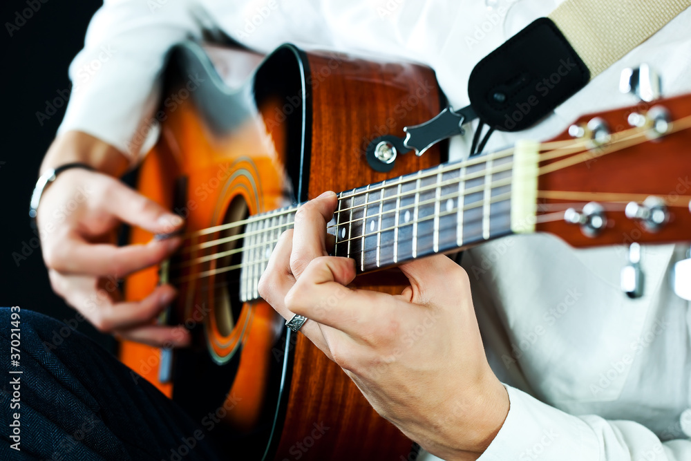 Fototapeta premium Playing on acoustic guitar