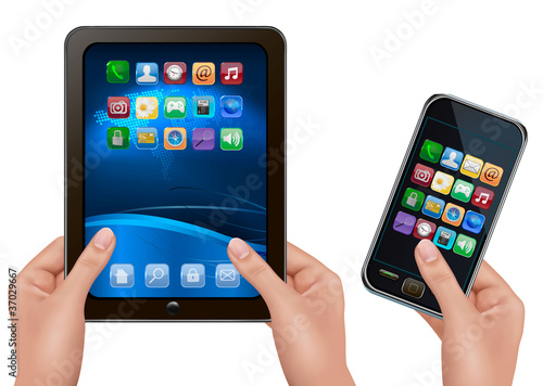 Hands holding tablet computer and mobil telephone.