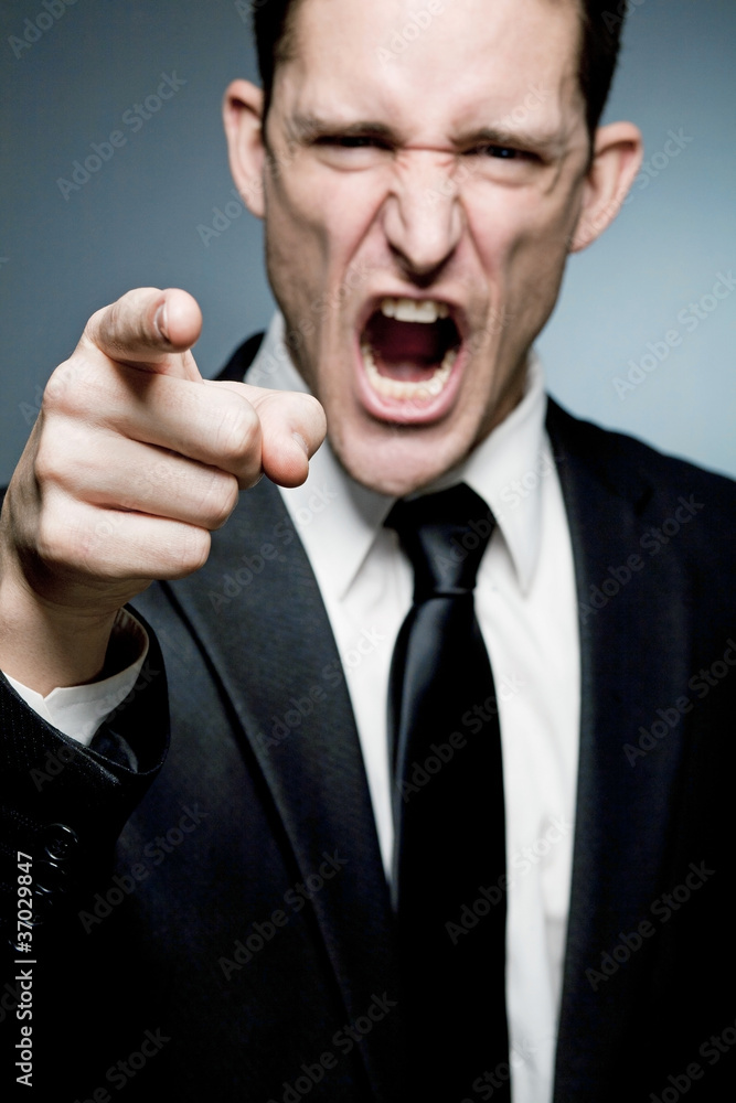Angry boss points finger at employee and screams. Angry boss points finger at employee and screams.