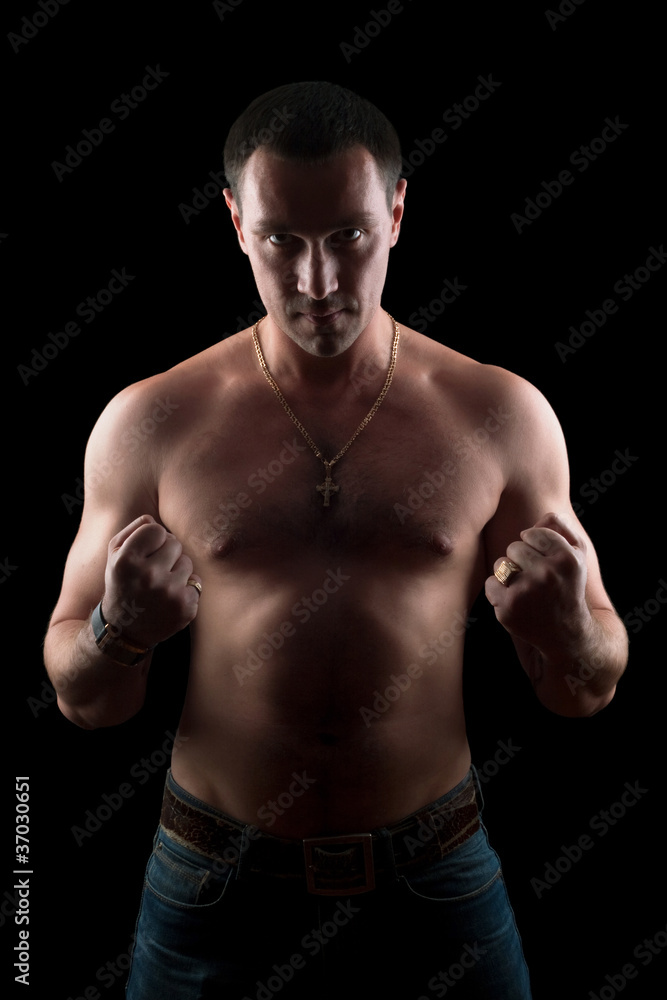 Fototapeta premium Portrait of a strong young man. Isolated
