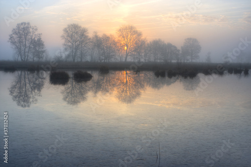 Rising sun above a frozen lake