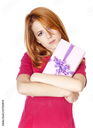 Sad red-haired girl with present box.