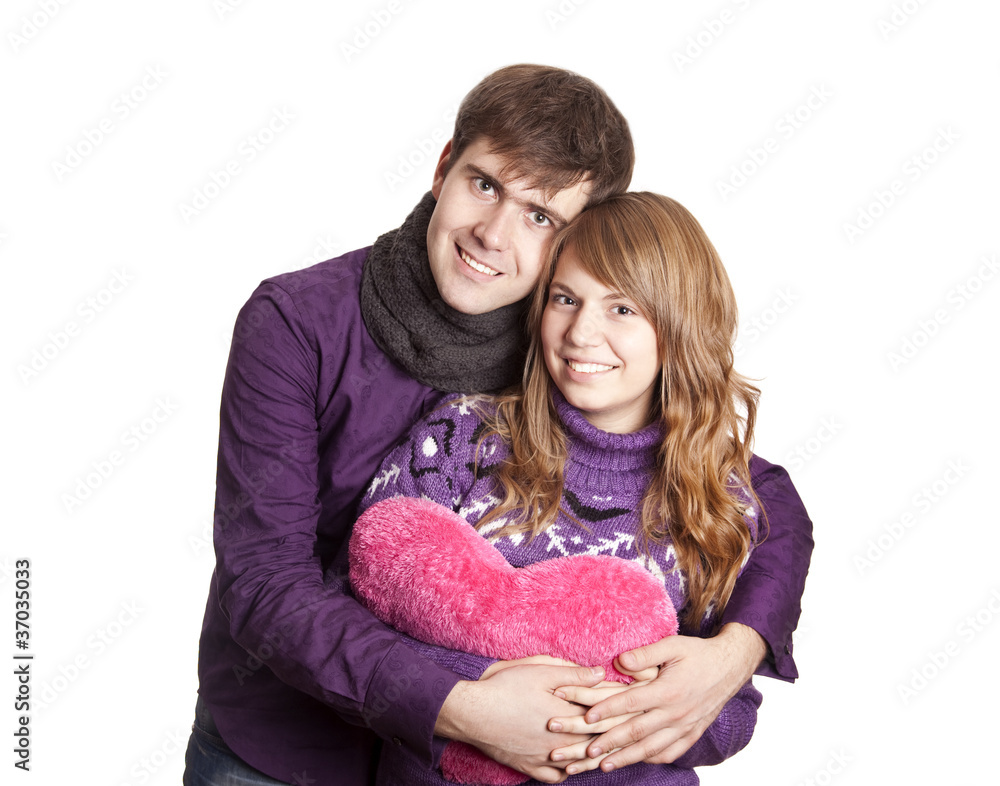 Beautiful couple with heart. Studio shot. Beautiful couple with heart. Studio shot.