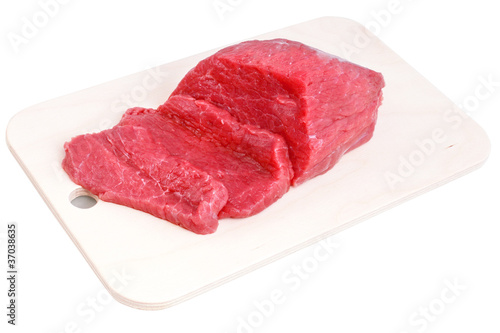 Cut of beef steak on meat hardboard. Isolated.
