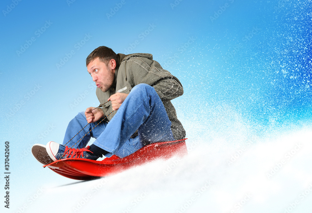 Young man flies on sled in the snow, concept