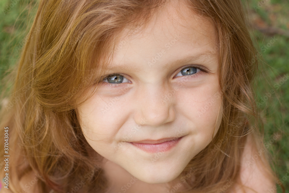 closeup portrait of a little girl with big blue eyes outdoors closeup portrait of a little girl with big blue eyes outdoors