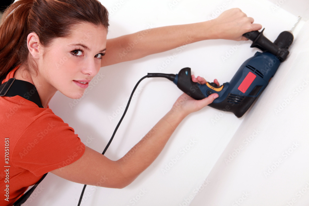 Young woman drilling Young woman drilling