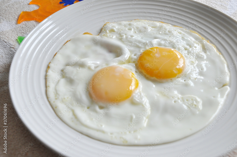 close up of fried egg on the plate close up of fried egg on the plate