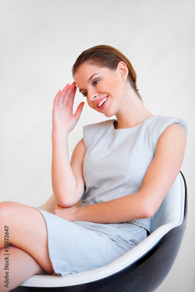 Young attractive business woman sitting on chair Young attractive business woman sitting on chair