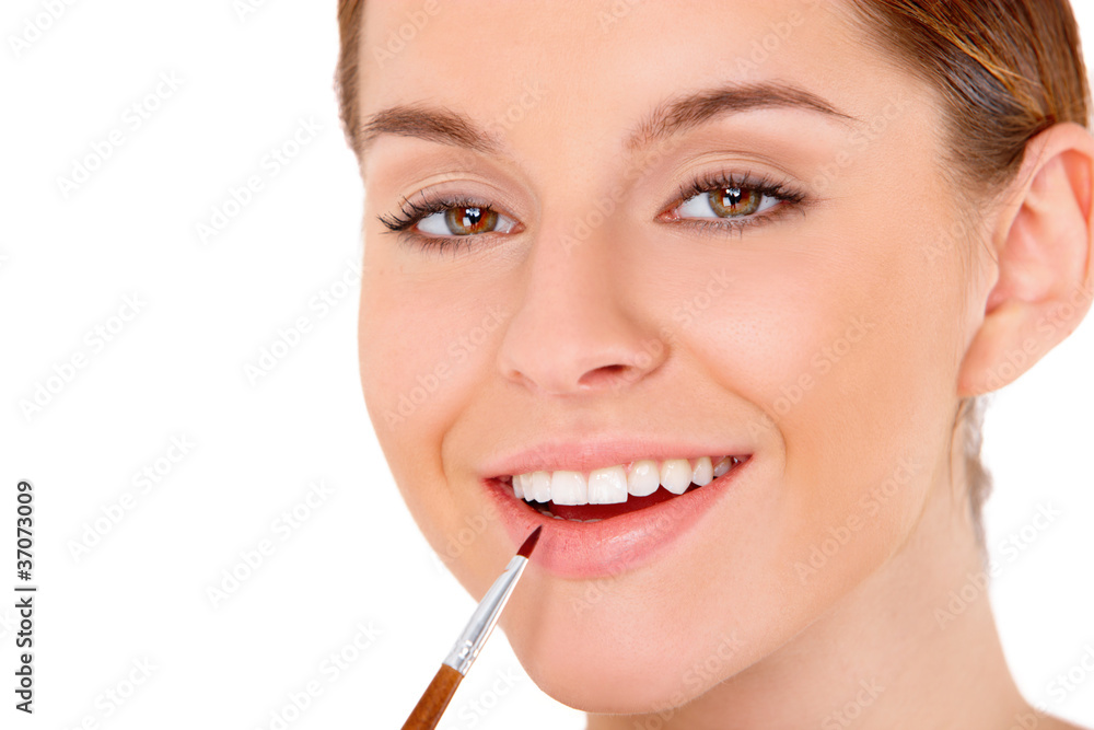 Portrait of beautiful young woman with cosmetics on white
