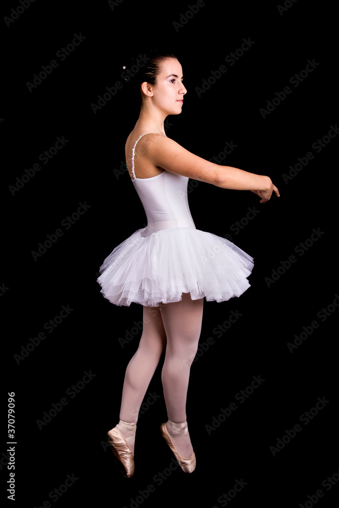 Young girl ballet dancer standing against black background Young girl ballet dancer standing against black background
