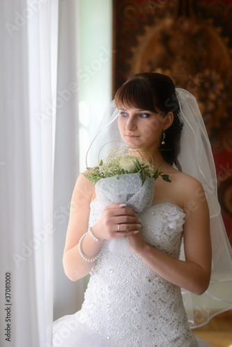 The bride look at window