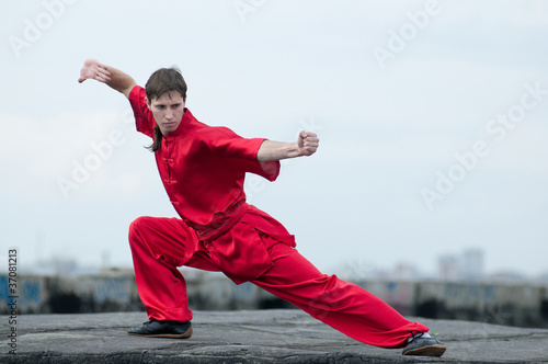 Wushoo man in red practice martial art photo