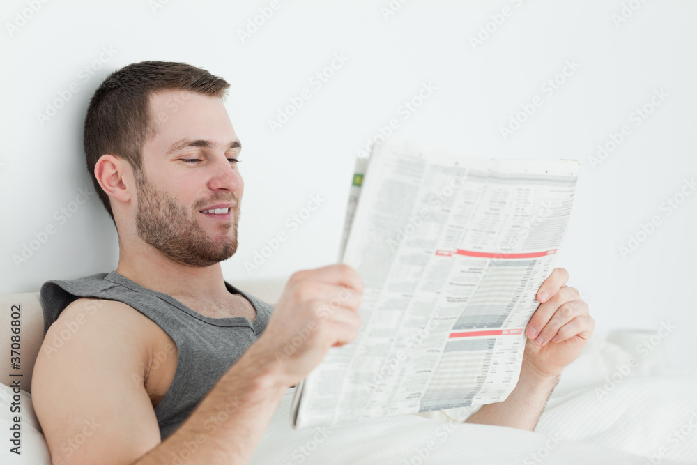 Attractive man reading a newspaper Attractive man reading a newspaper