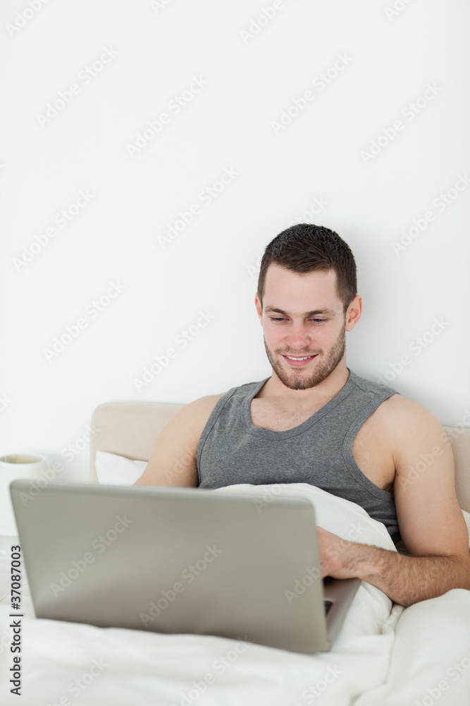 Portrait of a young man using a notebook