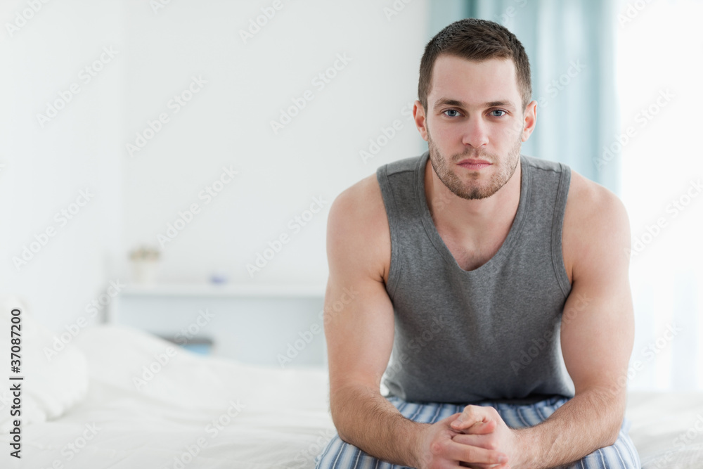 Man sitting on his bed Man sitting on his bed